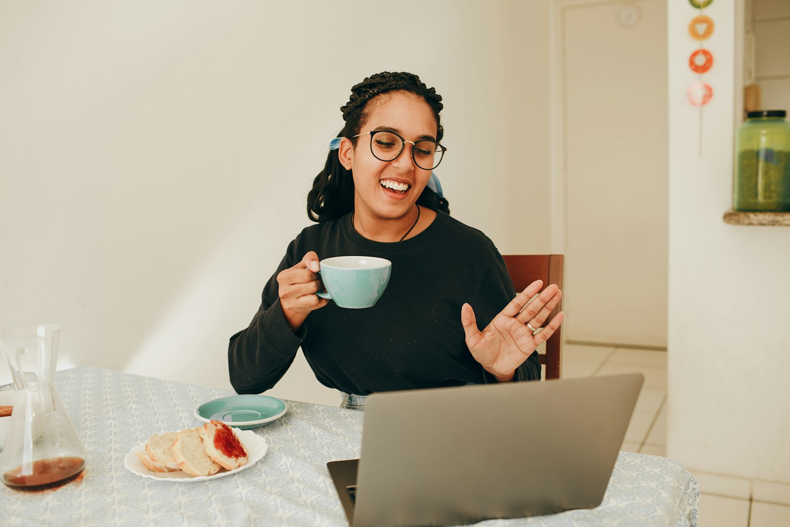 Photo by Helena Lopes woman in black long sleeve shirt holding white ceramic mug